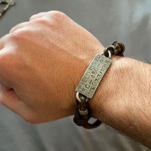 Men’s leather and metal bracket.